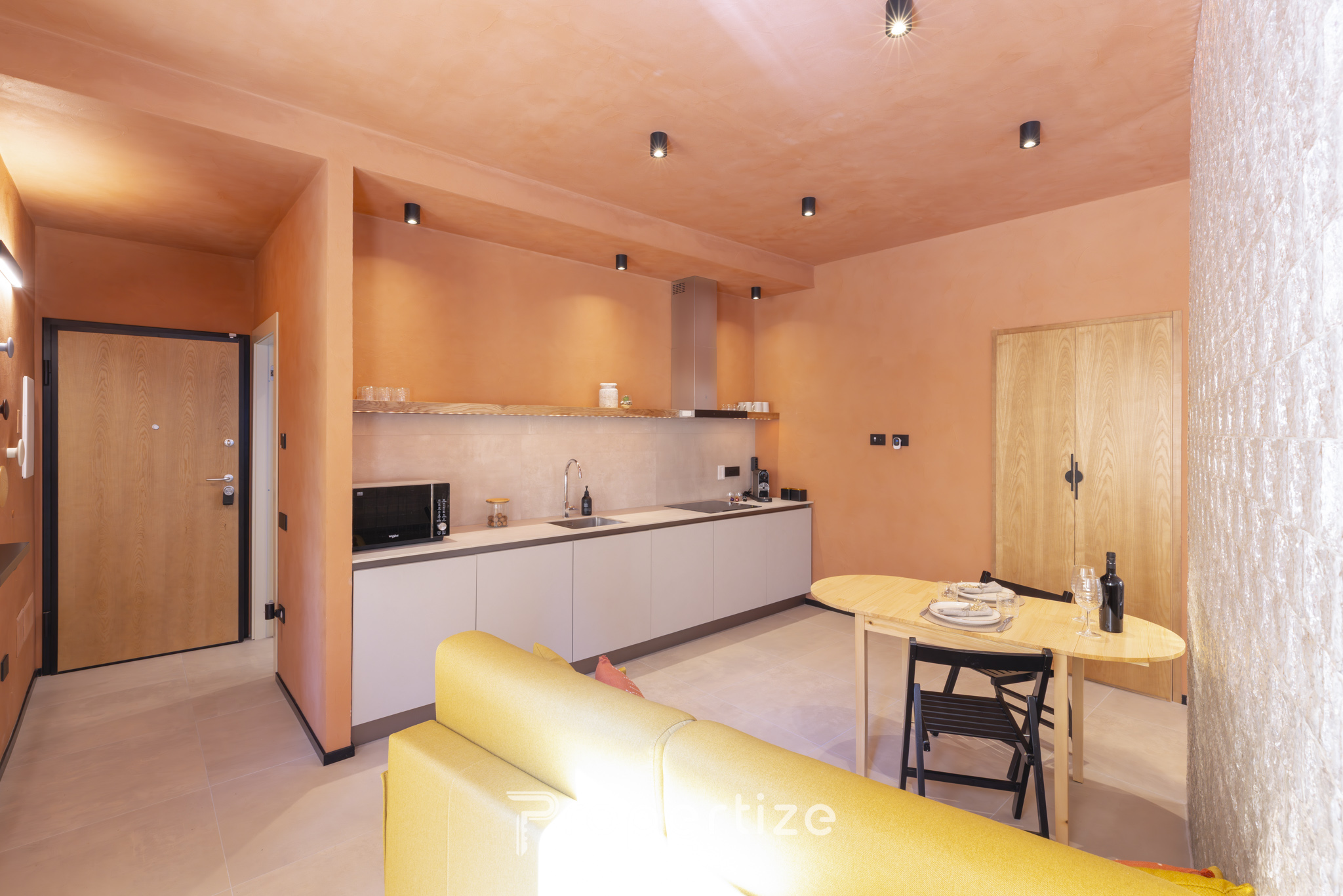 Full kitchen with espresso machine and dining area in Terra & Vidru Studio